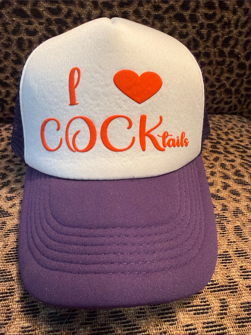 BRAND NEW Purple and White Trucker Hat with Orange Lettering.